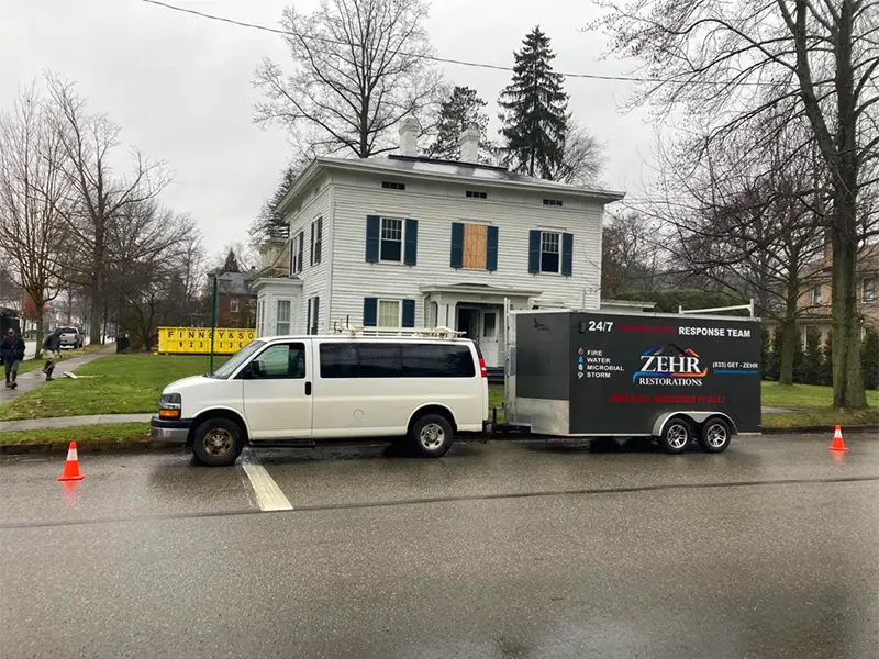 Zehr Restorations van parked near a home, certified restoration experts